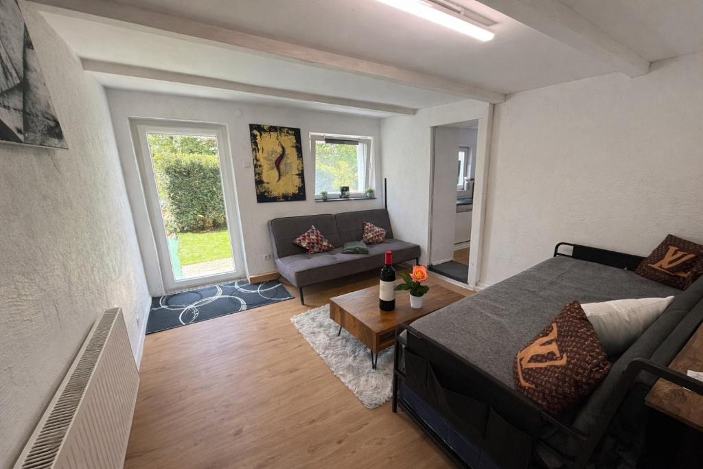 a living room with a bed and a couch at Schones Apartment mit Charme und privatem Garten in Schwieberdingen