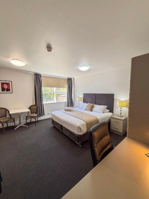 a large bedroom with a bed and a window at Gracelands Parkes in Parkes