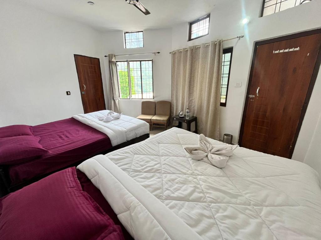 a bedroom with two beds with bows on them at Kedar Mount View in Sonprayag