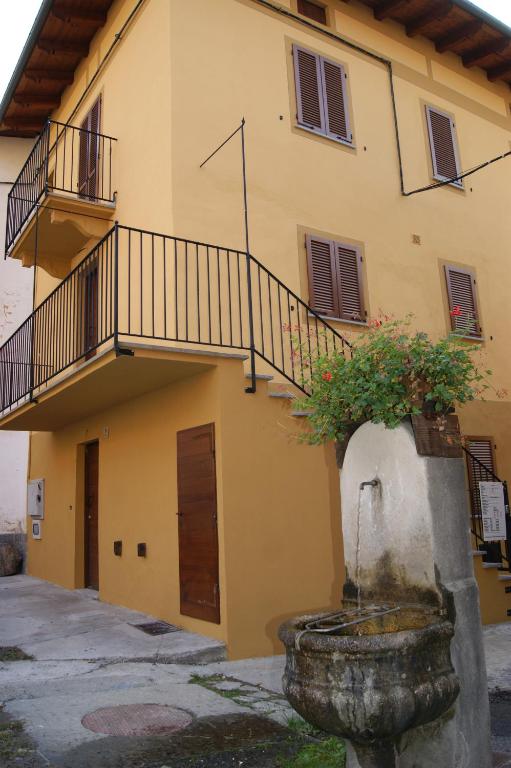 a building with a staircase and a fountain at Alloggio valle stura in Vinadio