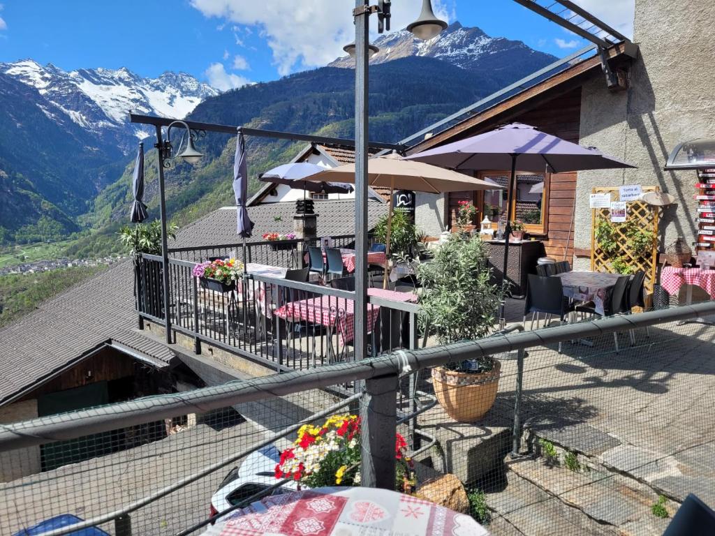 a balcony of a restaurant with mountains in the background at Osteria Anzonico in Anzonico