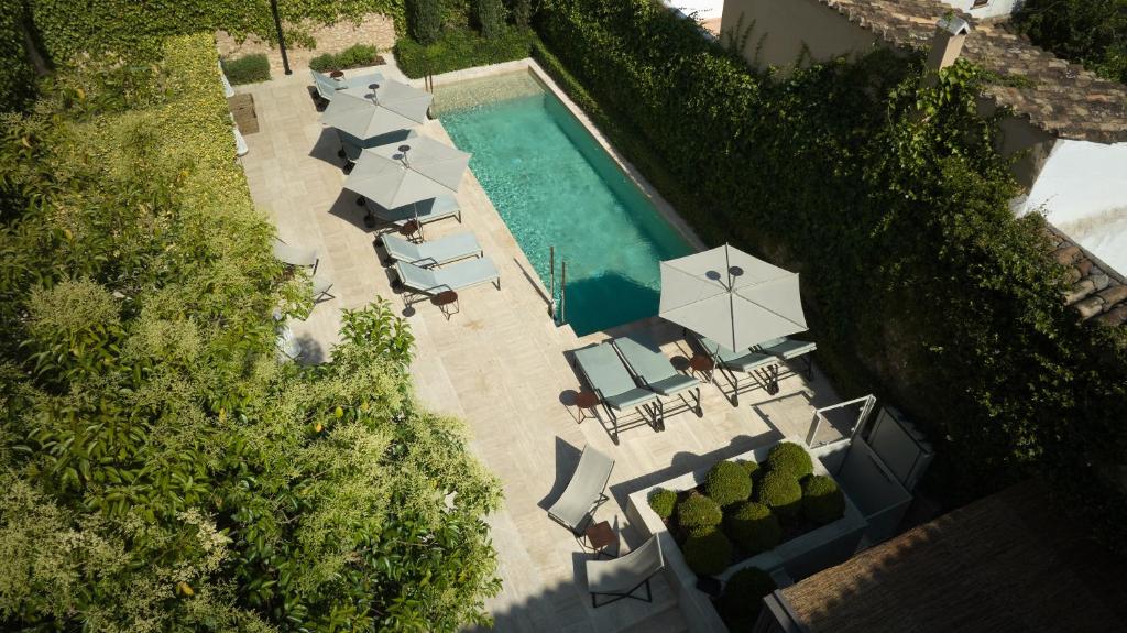 an overhead view of a swimming pool with umbrellas and chairs at Can Aulí Luxury Retreat in Pollença