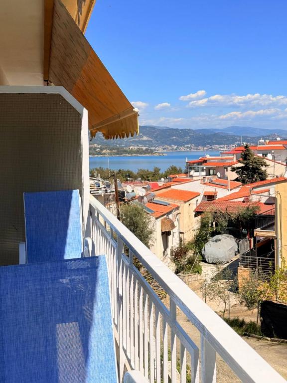 a balcony with a view of a city and the ocean at Helios in Kavála