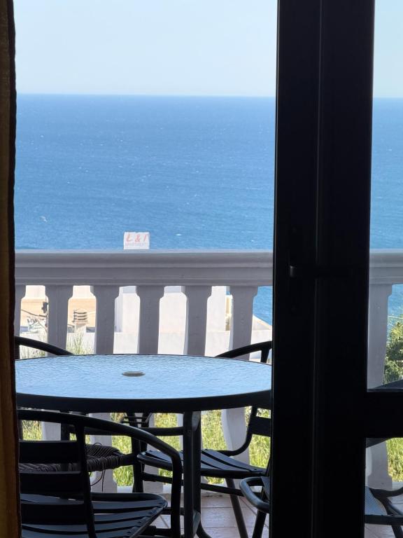 a table and chairs on a balcony with the ocean at Apartments Regata in Ulcinj