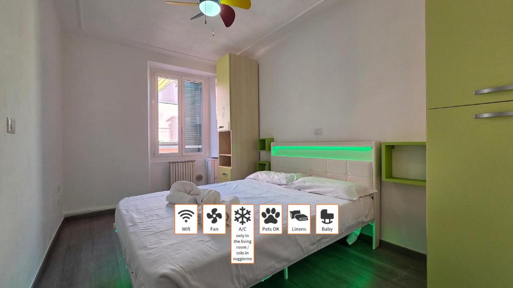 a bedroom with a bed with a sign on it at Arlecchino - By Turent in Pietra Ligure