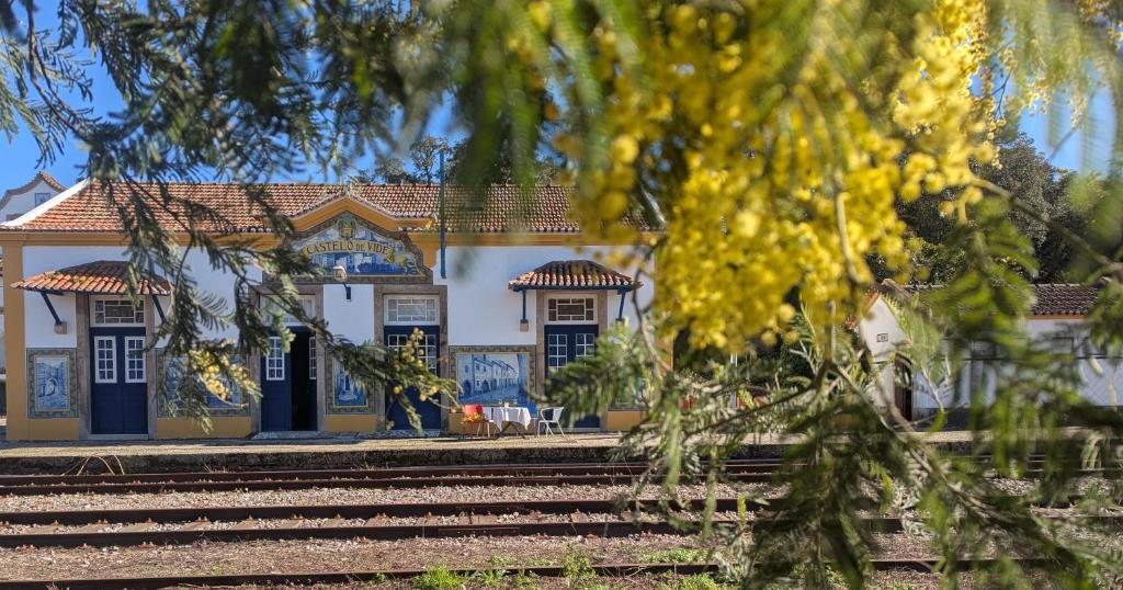 a house with blue doors and a train station at Pensão Destino in Castelo de Vide