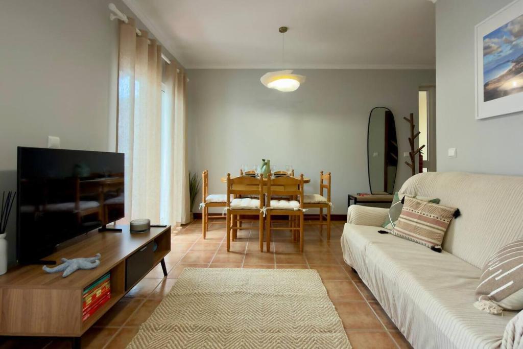 a living room with a couch and a table at Casa da Rosa by Mth in Porto Santo