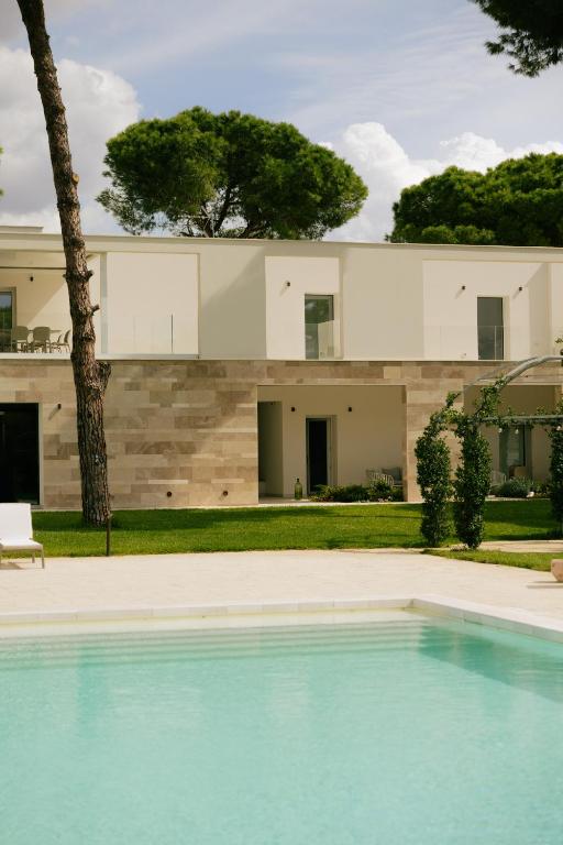 a house with a swimming pool in front of it at Villa Sanarica in Taranto