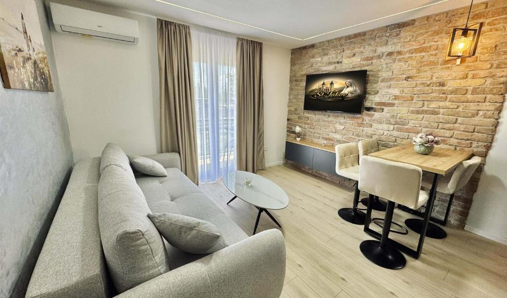 a living room with a couch and a table at Apartments St Jakov in Međugorje