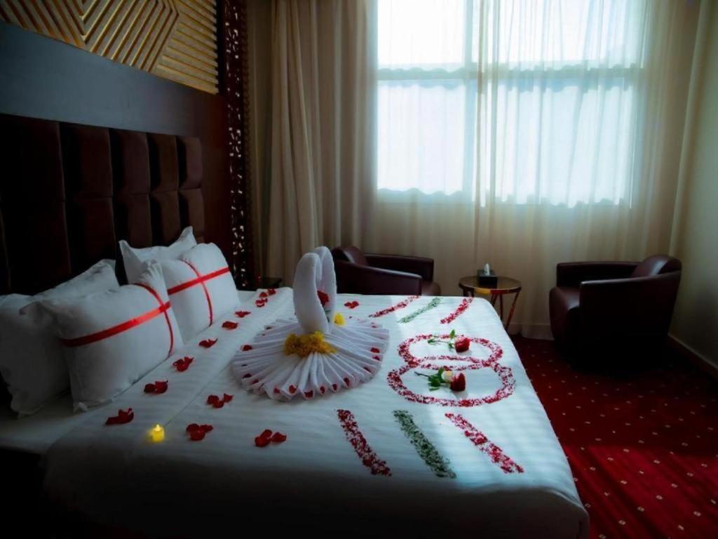 a hotel room with a bed with flowers on it at فندق السلطان ان Alsultan Inn Hotel in Jazan