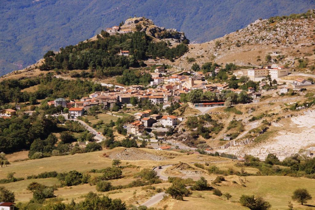 a village on a hill with a mountain at Casa Vacanze VENDITTO in Pietraroia