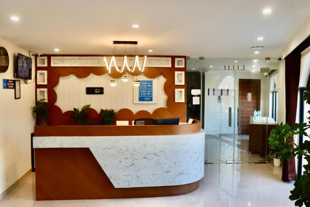 a lobby of a hospital with a reception desk at Waves Residency in Chennai