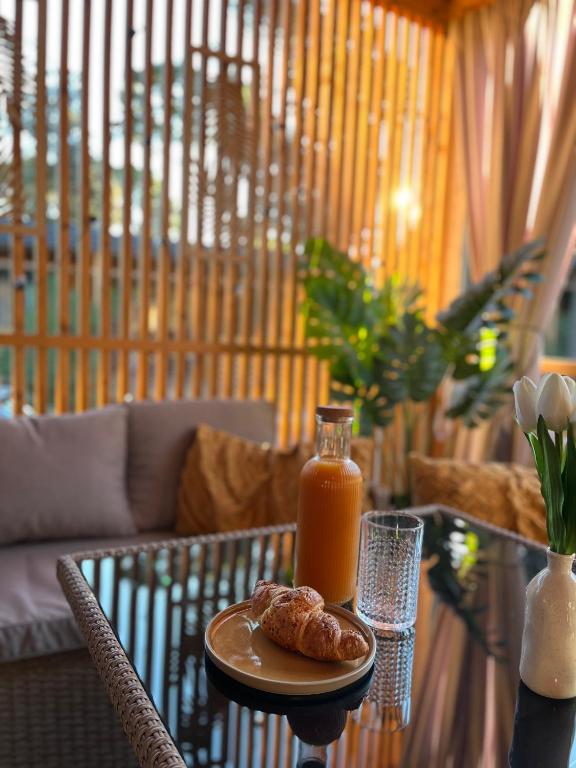 a table with a plate of food and a glass of orange juice at Mobile Home Sea Heaven in Biograd na Moru