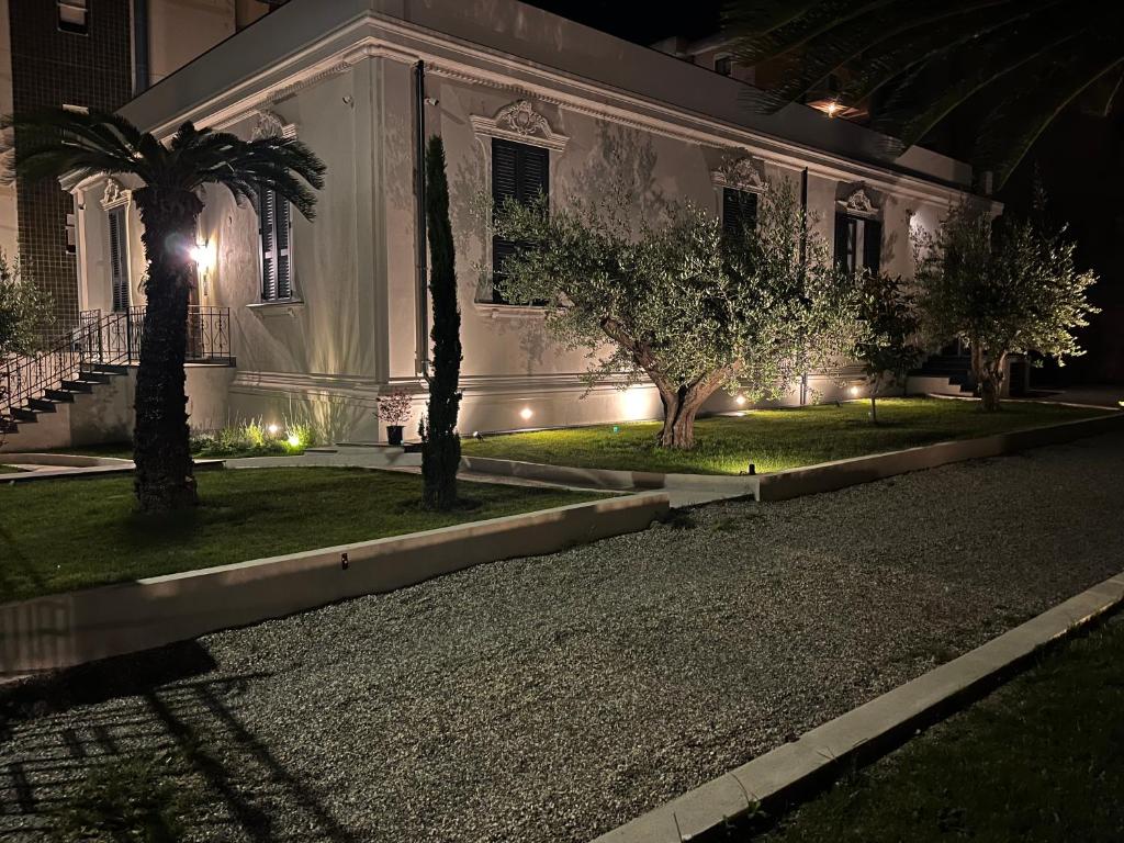 a house lit up at night with trees and lights at Dimora di Duen - Villa Storica di Charme in Villa San Giovanni