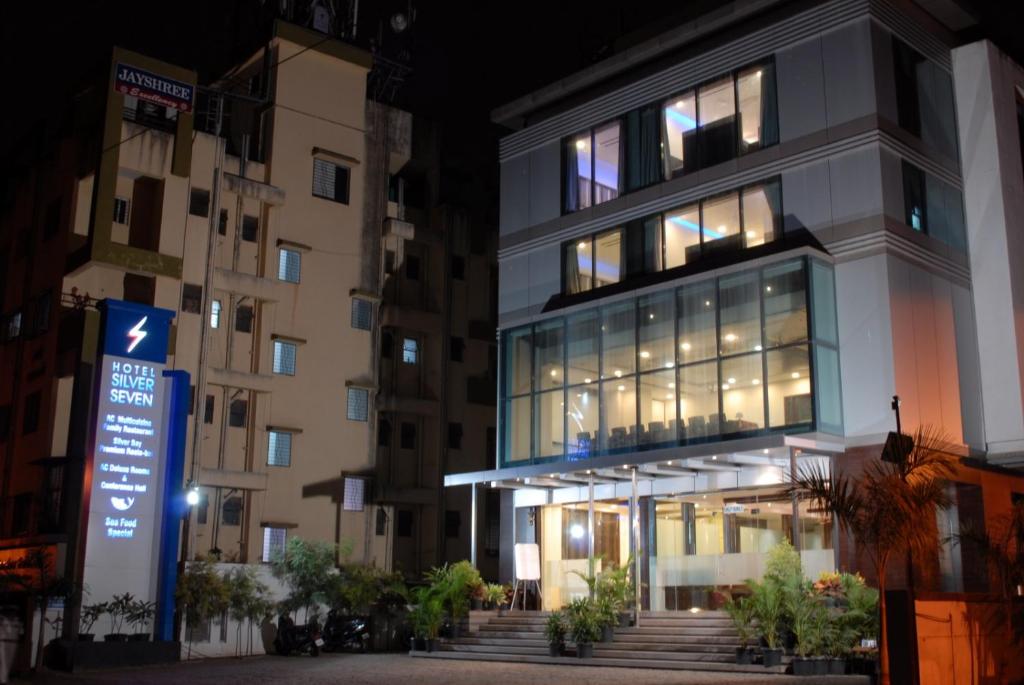 a building with a sign in front of it at Hotel Silver Seven in Jāmb