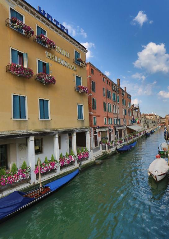a view of a canal with buildings and boats at Hotel Arlecchino in Venice