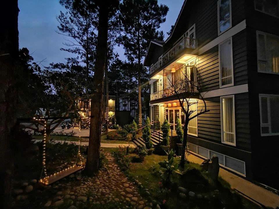 a house with lights on the side of it at night at AP HOME - Lakeside in Ấp Ðinh An (1)