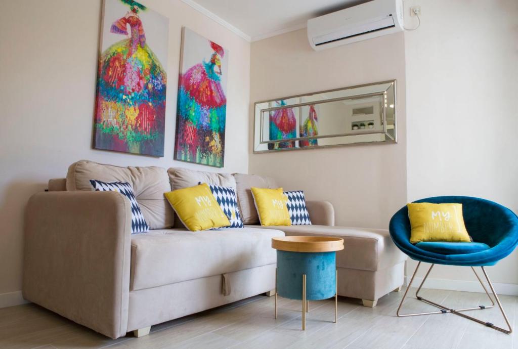a living room with a couch and a blue chair at Apartman Nora Herceg Novi in Zelenika