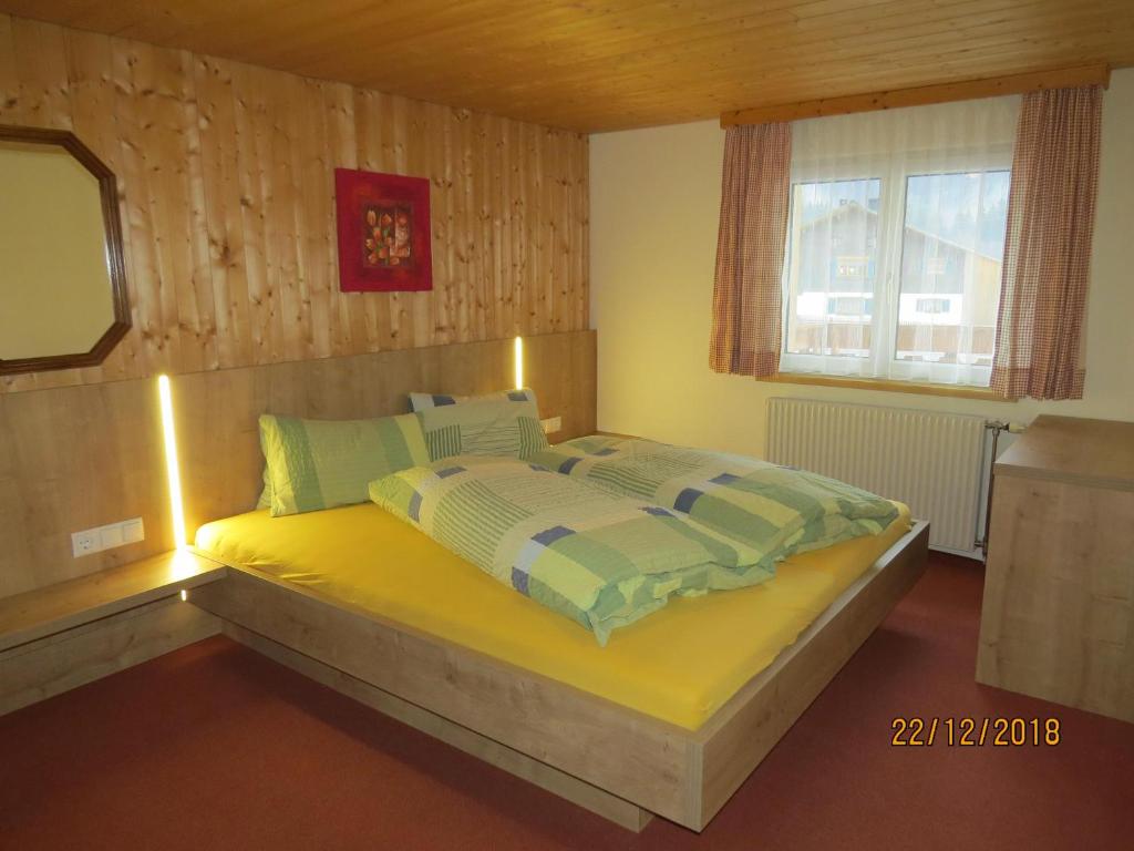 a bedroom with a bed with lights on it at Ferienwohnung Birgit in Sankt Gallenkirch