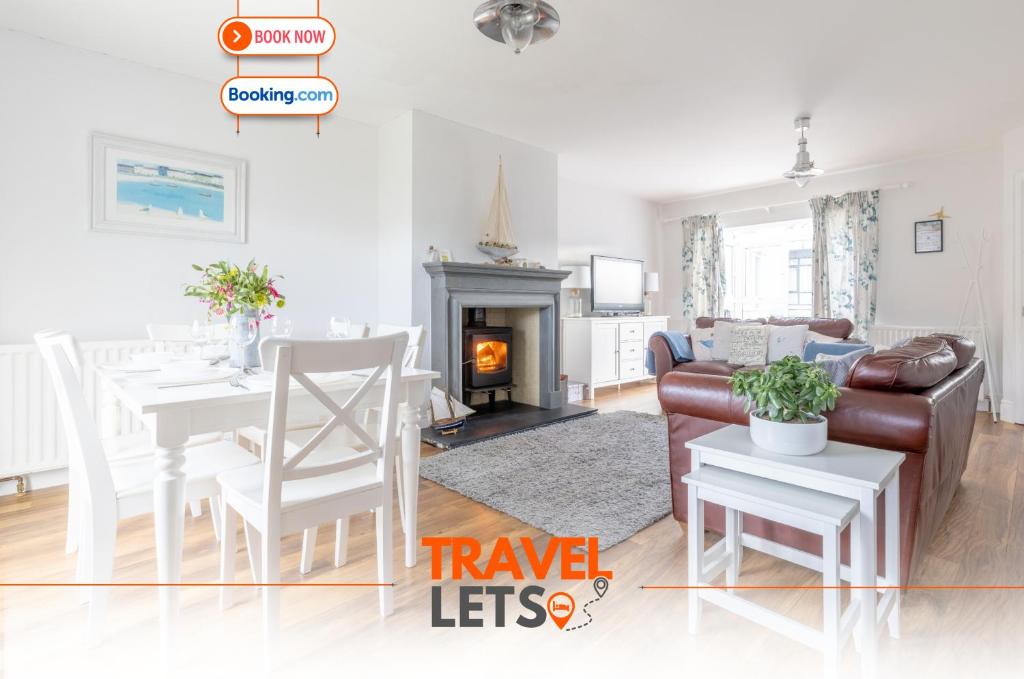 a living room with a couch and a table at 3 Bedroom House Near Beach By Travel Lets Holiday Rentals Donegal With Private Garden in Downings