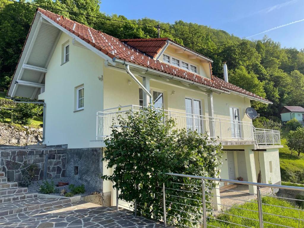 a house on the side of a hill at Vineyard cottage SkyView in Semič