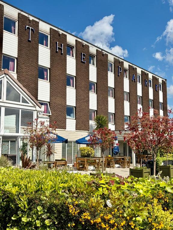 a large building with tables and chairs in front of it at The Park Hotel in Liverpool