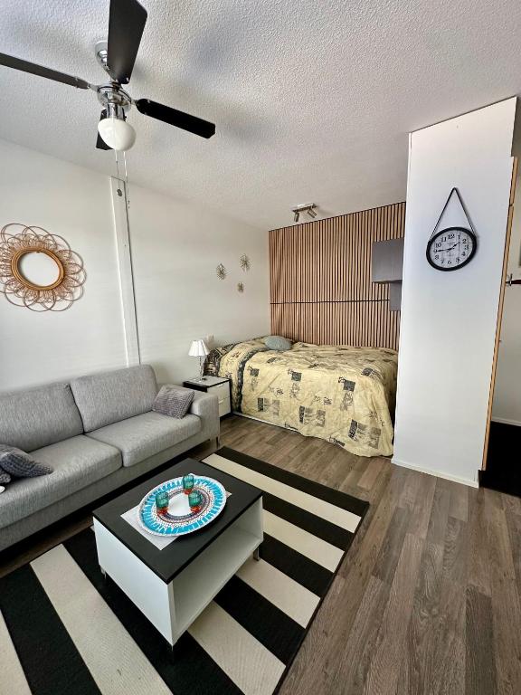 a living room with a couch and a bed at Pohjankaira in Rovaniemi