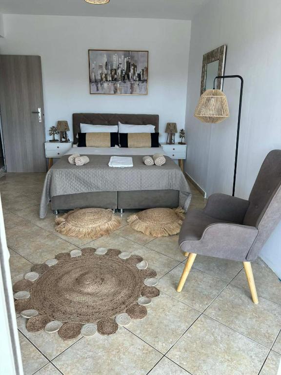 a bedroom with a bed and a chair and a table at Luxury Villa Vista in Tsouknída