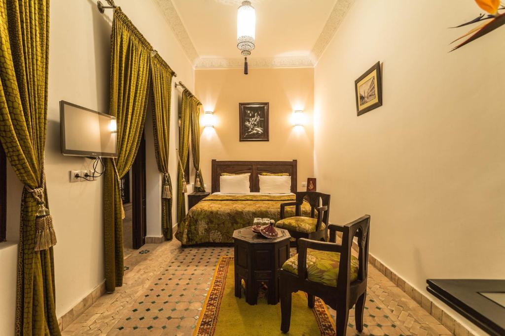 Postel nebo postele na pokoji v ubytování Riad Nasreen