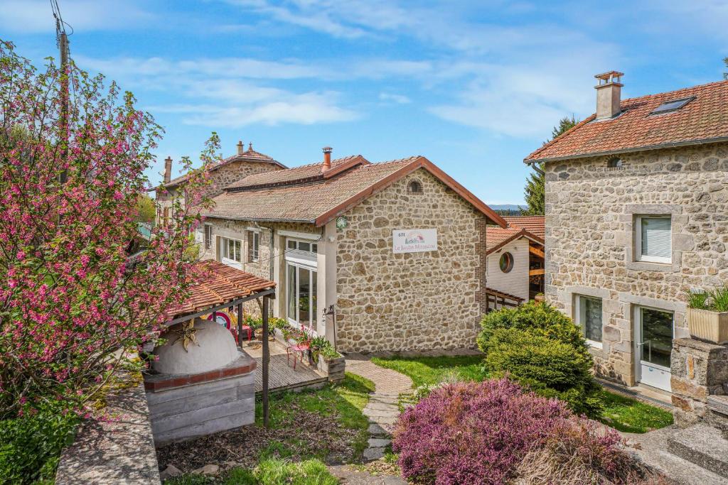 a stone house with a garden in front of it at Gîte Le Jardin Mirandou in Raucoules