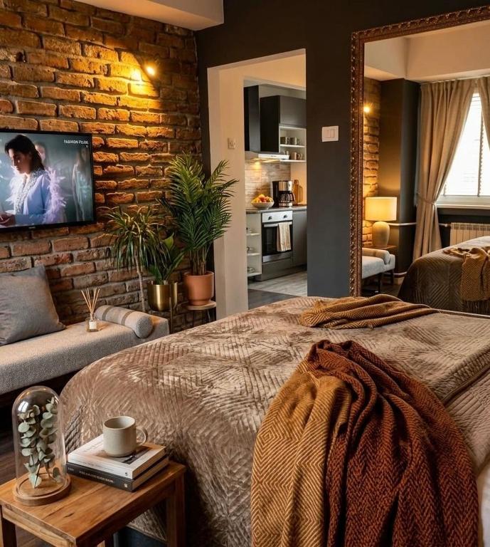 a bedroom with a large bed and a brick wall at Vintage Cozy Suite in Vodno