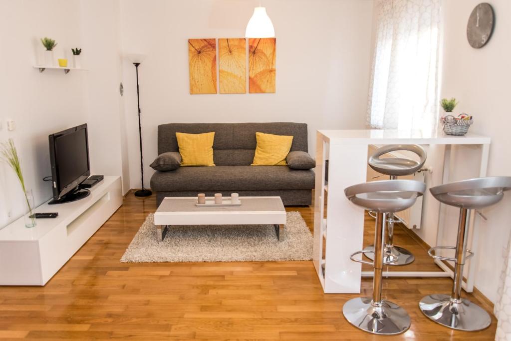 a living room with a couch and a table at Apartment Roko in Osijek