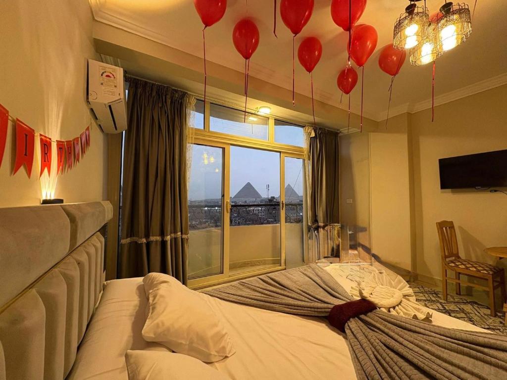a bedroom with red balloons hanging from the ceiling at Grand pyramids view & Jacuzii in Cairo
