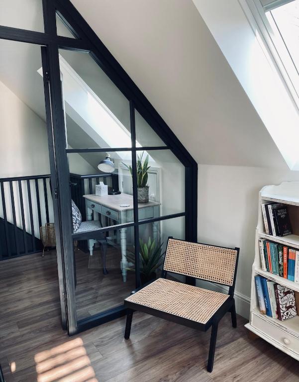 a room with a bench and a table and a desk at Guest house in Compton in Winchester
