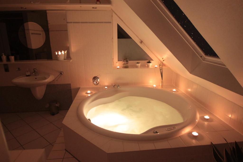 a bathroom with a bath tub with lights in it at Erholung und Wellness in Dänschendorf