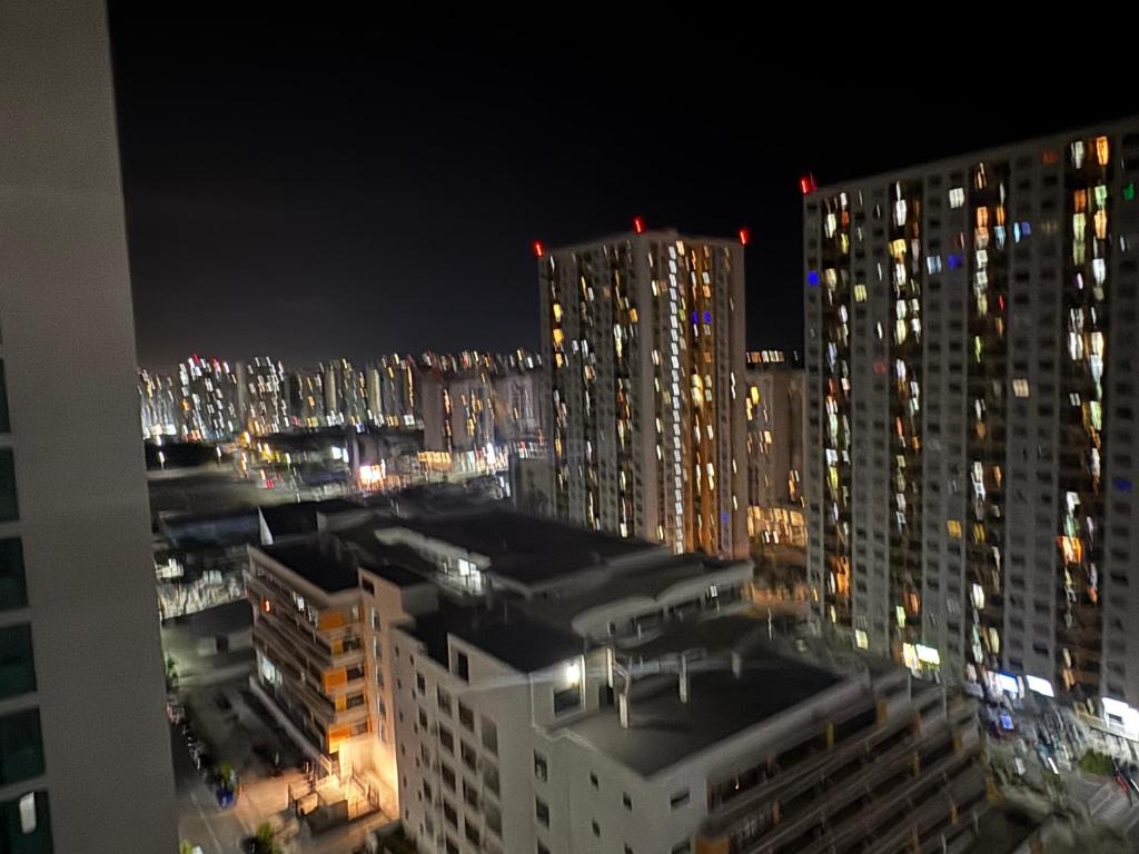 a view of a city at night with tall buildings at Home Transit Hulhumale' Phase 2 in Male City