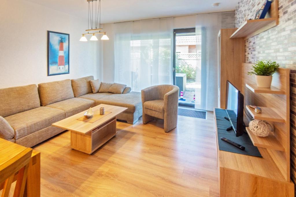 a living room with a couch and a table at Matjesliebe in Dornumersiel