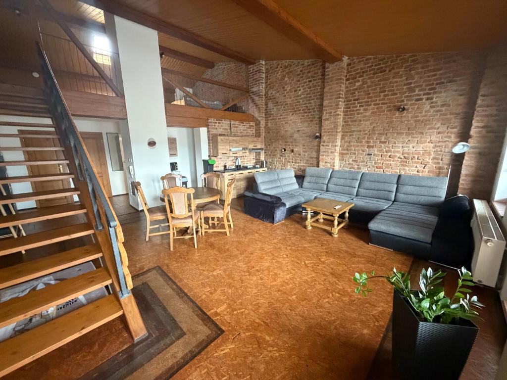 a living room with a couch and a table at Ubytování u Šimků in Broumov