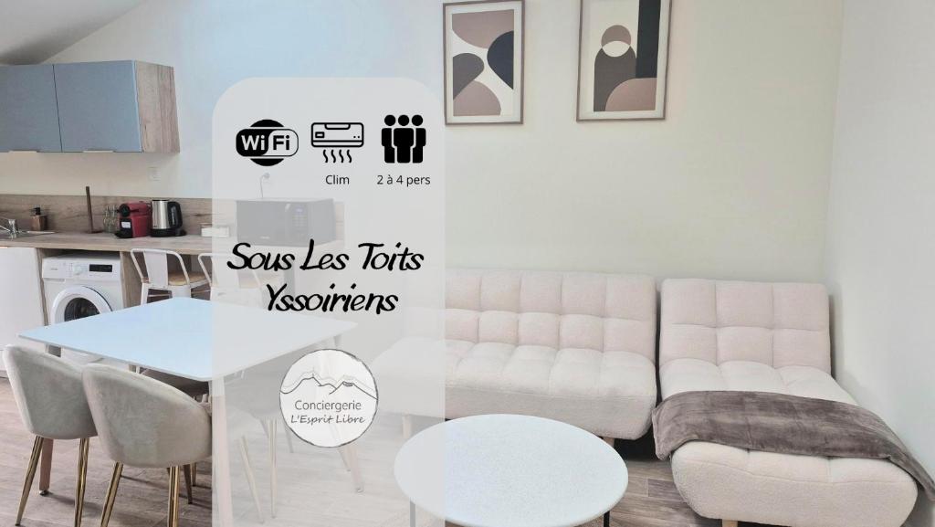 a living room with a table and a white couch at Sous les Toits Yssoiriens - Centre-Ville in Issoire