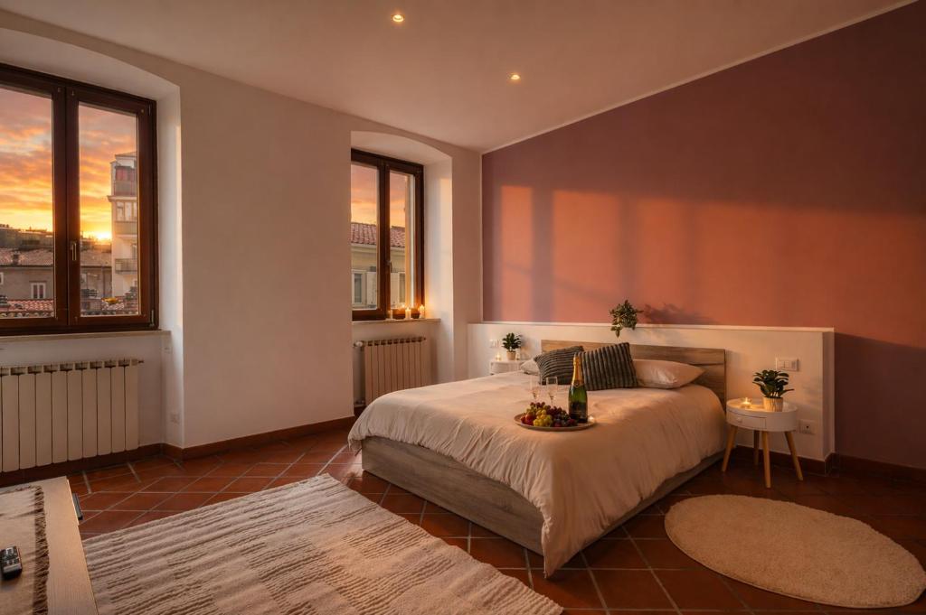 a bedroom with a bed and a large window at Marconi Home in Trieste