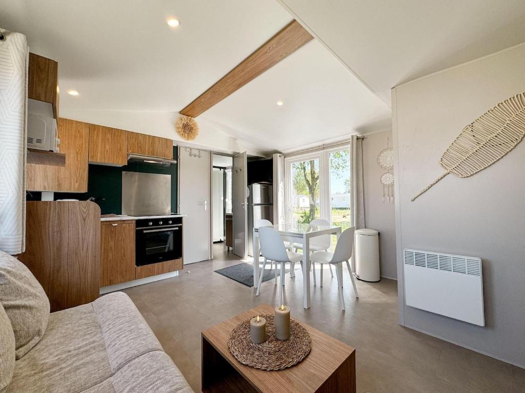 a living room and kitchen with a table and chairs at Chalet Duin & Zee 44, Renesse in Renesse
