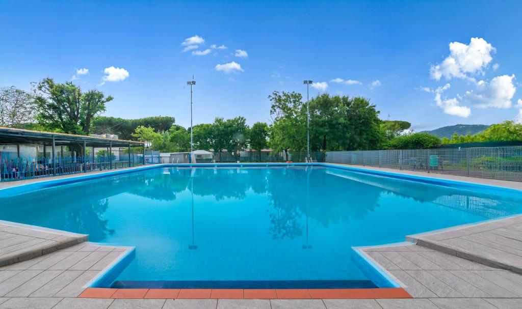 a large swimming pool with blue water at Campeggio La Quiete in Marina di Massa