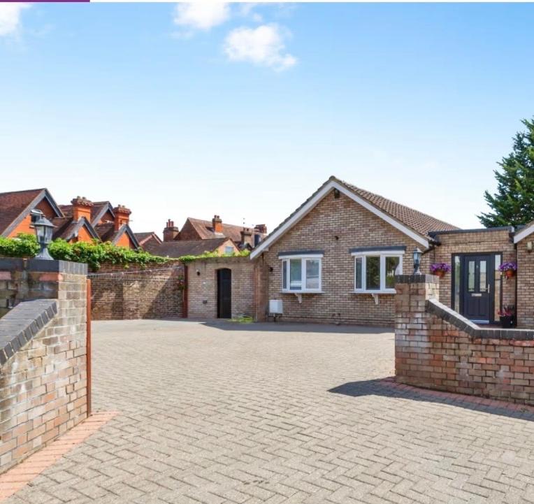 a large brick house with a brick driveway at Windsor side in Datchet