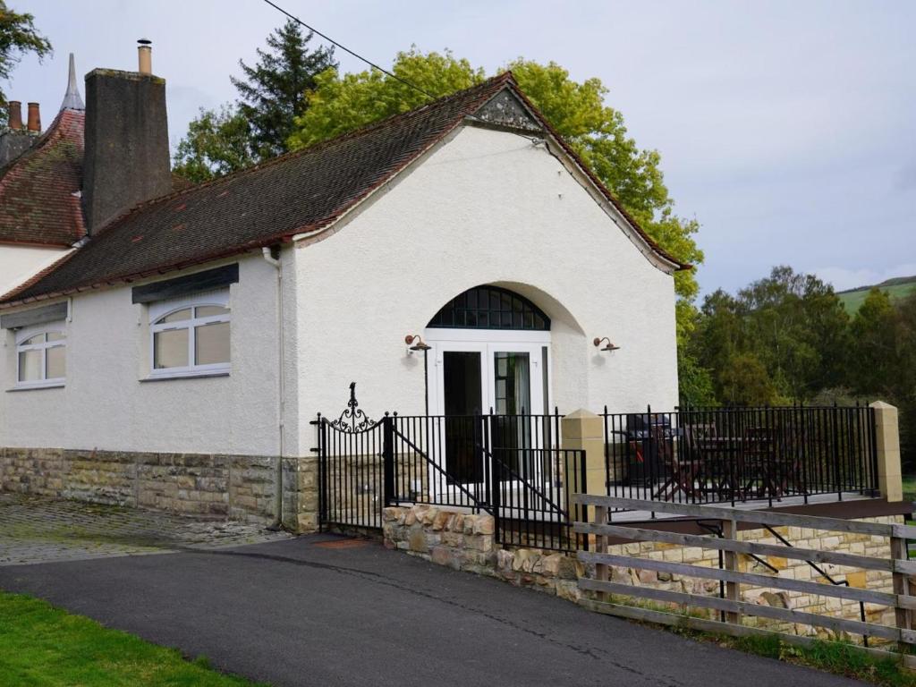 a white house with a gate and a fence at 2 Bed in Hawick oc-86021 in Hawick