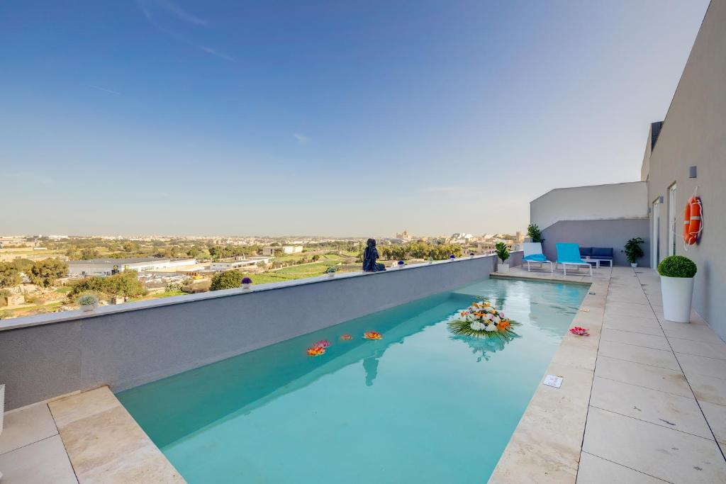 a swimming pool on the roof of a building at Superlative 3BR Penthouse, Private Pool and Views in Hal Ghaxiak