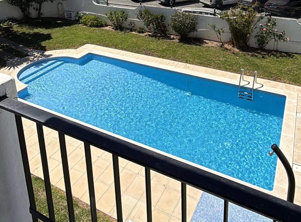 a swimming pool on top of a balcony at Apartamento Oura - Albufeira in Bicas