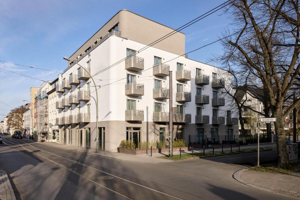 a white building on the side of a street at appartello - smarttime living Berlin in Berlin