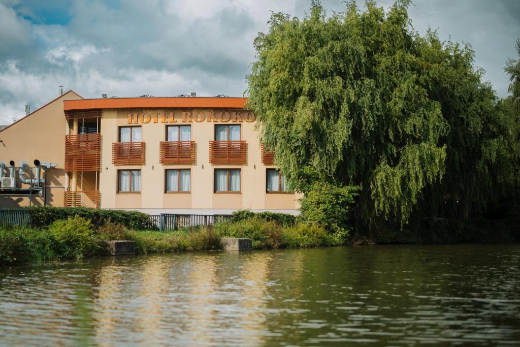 a building on the side of a body of water at Hotel Rokoko Košice - free parking in Košice