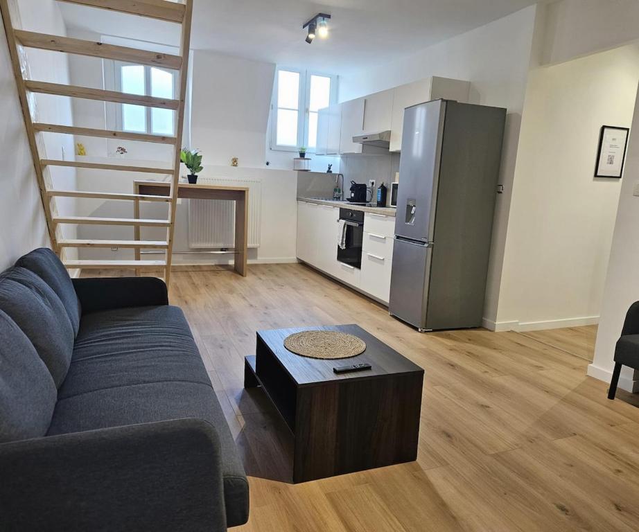 a living room with a couch and a kitchen at Atomium Apartment 2 in Brussels