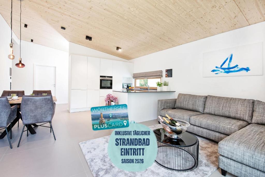 a living room with a couch and a table at Apartment Velden - 24 Home im Zentrum inklusive Strandbadeintritt in Velden am Wörthersee